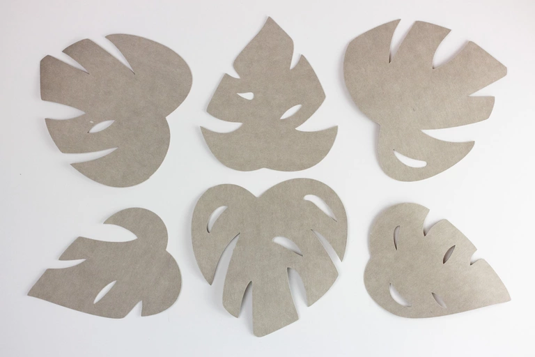 Monstera leaves cut out of paper fabric.