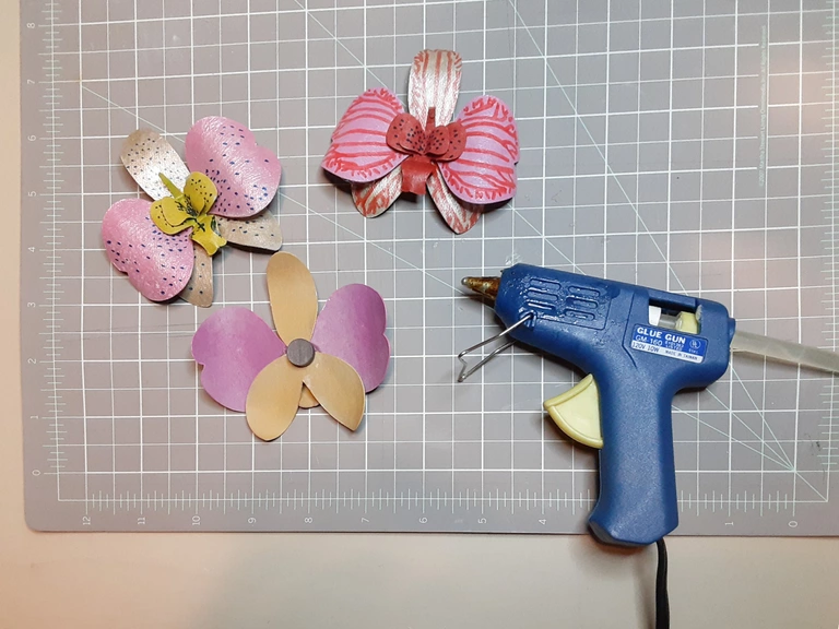 Glue magnets to the back of orchid flowers.